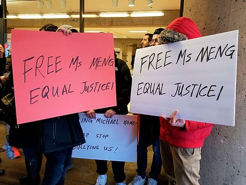 Protestors stand outside a Vancouver courtroom on January 20, 2020, pressing for the release of a senior Chinese telecommunications executive fighting extradition to the United States, were paid actors, they told local media.