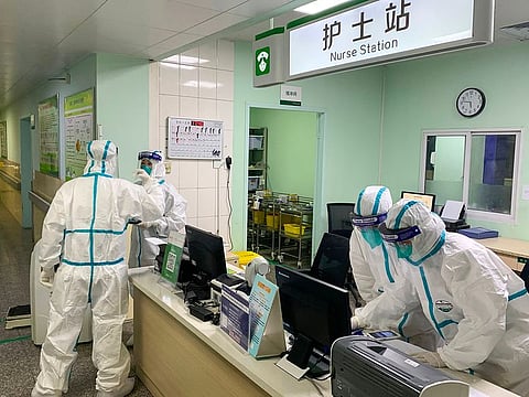 Medical staff members wearing protective suits at the Zhongnan hospital in Wuhan in China's central Hubei province.