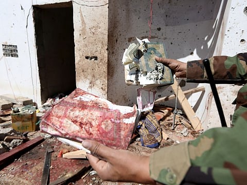 A soldier shows a destroyed copy of holy Quran at the site of a Houthi missile attack on a military camp’s mosque in Marib, Yemen January 20, 2020.