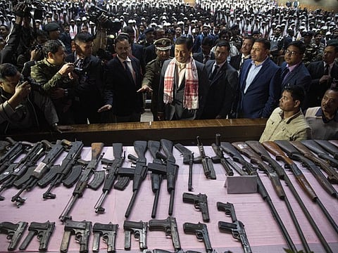 Assam state Chief Minister Sarbananda Sonowal, centre, inspects arms and ammunition handed over by cadres of different rebel groups during a surrender ceremony in Gauhati, India, Thursday.