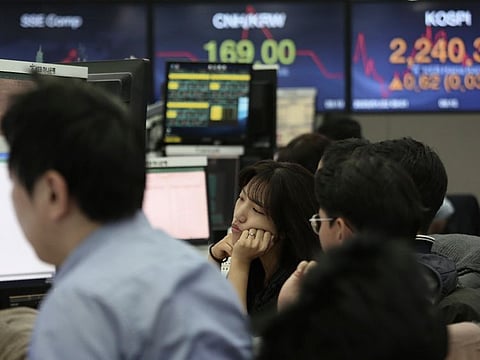 A currency trader watches monitors at the foreign exchange dealing room of the KEB Hana Bank headquarters in Seoul, South Korea, Wednesday, Jan. 22, 2020. Shares advanced in early Asian trading after a slide in U.S. stocks Tuesday as a virus outbreak in China rattled global markets.