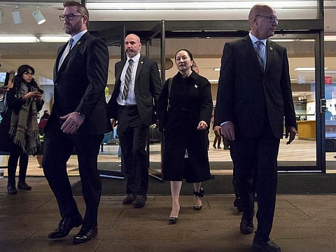 Meng Wanzhou, chief financial officer of Huawei, is flanked by security as she leaves B.C. Supreme Court in Vancouver, Thursday, January 23, 2020.