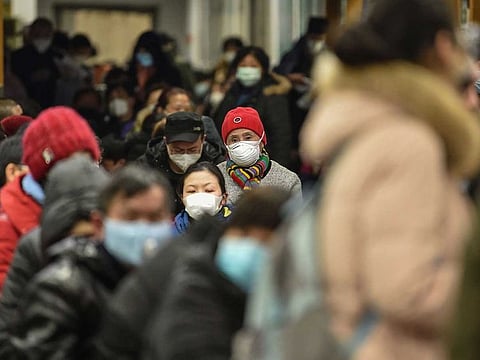 People wearing facemasks to help stop the spread of a deadly virus which began in the city, wait at Wuhan Red Cross Hospital in Wuhan.