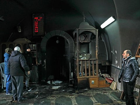 Palestinians inspects the damage on the aftermath of a suspected Jewish arson attack that targeted mosques in the Palestinian neighbourhood of Beit Safafa, in Occupied Jerusalem, on January 24, 2020.