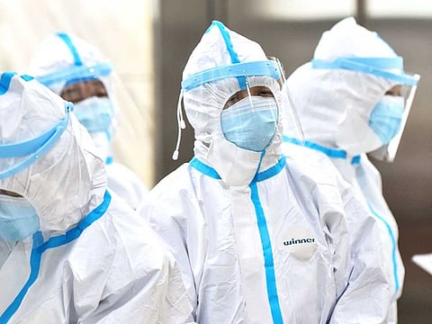 Medical staff members wearing protective clothing to help stop the spread of the deadly virus