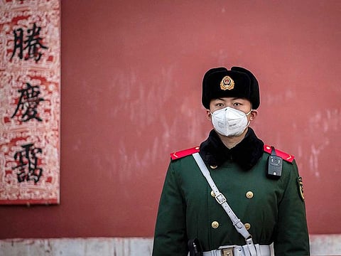 A paramilitary police officer wearing a protective facemask to help stop the spread of the Corona virus, which originated in the central city of Wuhan.