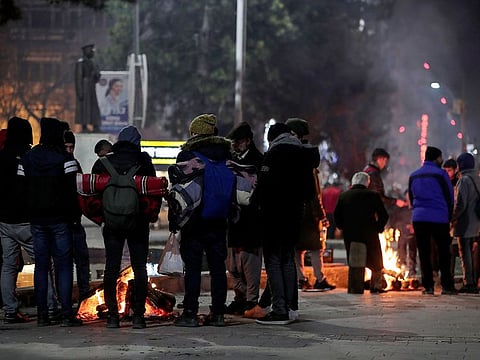 People gather around fires to spend the night following Friday's earthquake that destroyed their houses, in Elazig, eastern Turkey, late Saturday, Jan. 25, 2020. More than 24 hours after a powerful earthquake hit eastern Turkey rescuers continued to pull survivors from under collapsed buildings Sunday.