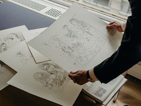 John Szoke, a dealer and specialist in Picasso, holds a real print by the artist, in his Manhattan office on January 18, 2020. Spurred by advances in photomechanical reproduction, forgers are increasingly selling unauthorised copies of famous works on the internet, and elsewhere.