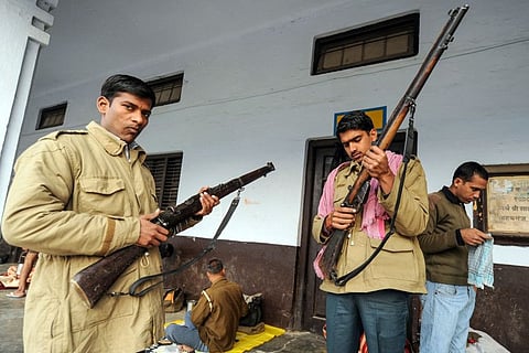 In this photo taken on February 7, 2012, Uttar Pradesh police personnel check their Lee-Enfield .303 rifles as they prepare for their respective polling booth security duties at a school in Ayodhya. Police in northern India on January 26 bid goodbye to the historic British-era bolt-action rifles after using them for one last salute during the annual Republic Day parade. The Lee-Enfield .303 rifle was the main firearm of British colonial military forces and, despite being designated "obsolete" around 25 years ago, it has been the main weapon used by police in Uttar Pradesh state over seven decades.