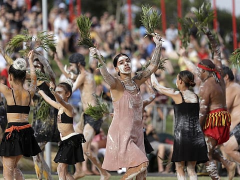 Aboriginal woman Jordan Davis, center, performs with the Buja Buja dance troupe during the Wugulora Indigenous Morning Ceremony as part of Australia Day celebrations in Sydney on Sunday.