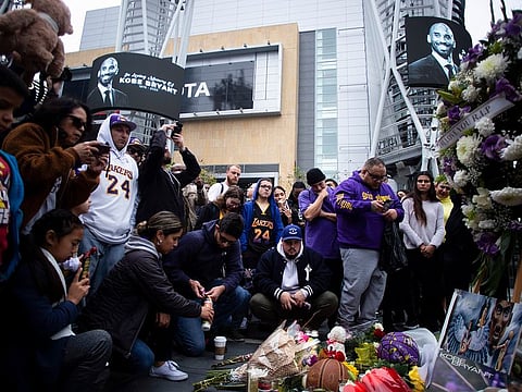 Mourners gather at a makeshift memorial for Kobe Bryant, the retired Los Angeles Lakers star, outside of the Staples Center in Los Angeles, Jan. 26, 2020.