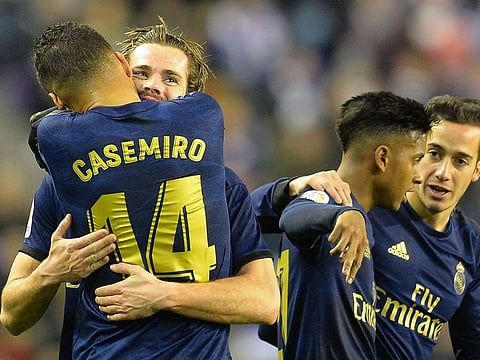 Real Madrid’s Nacho, 2nd left, celebrates with Casemiro after scoring.