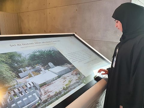 Amira Al Aamri, research associate at Khalifa University of Science and Technology, displays the digital record of Sas Al Nakhel cemetery.