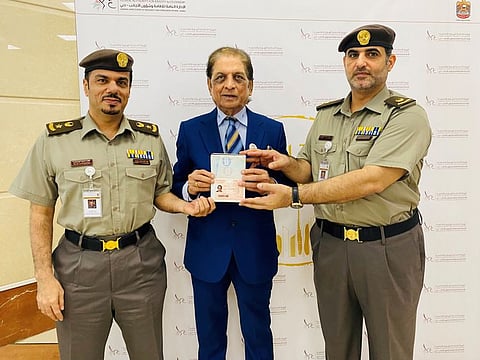 Ramesh Shukla receiving the Golden Visa from GDRFA (Dubai) officials