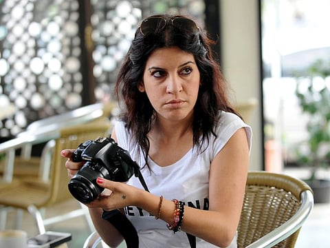 In this file photo taken on October 7, 2013 Human rights defender, internet-activist and blogger Lina Ben Mhenni, who was previously nominated for the Nobel Peace prize, holds a camera as she arrives to attend the trial of two Tunisian rappers Mustapha Fakhfakh and Aymen El-Fikih at the court in the Tunis suburb of Ben Arous. Ben Mhenni, an activist blogger who was prominent during the popular uprising that led to the downfall of President Zine El Abidine Ben Ali, died on January 27, 2020 at the age of 36 from long-term complications of kidney failure. / AFP / Fethi Belaid AND Fethi Belaid
