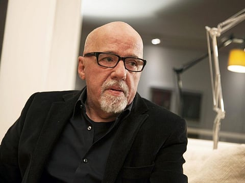 In this Dec. 19, 2014 file photo, Brazilian author Paulo Coelho appears during an interview at his apartment, in Geneva, Switzerland.