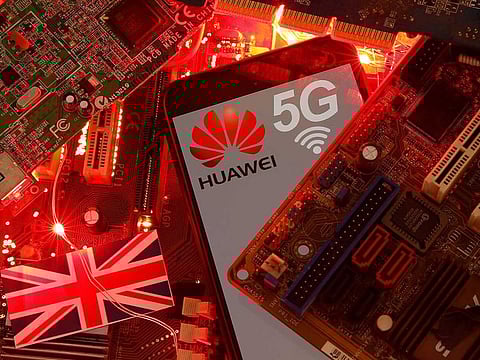 The British flag and a smartphone with a Huawei and 5G network logo are seen on a PC motherboard in this illustration picture.