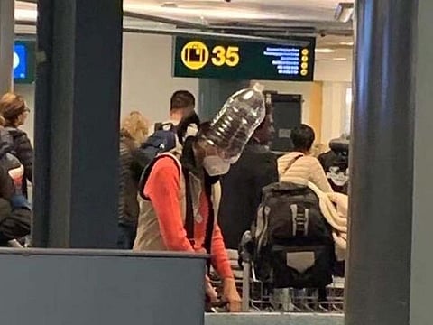 People are using water bottles and other items to cover their mouths