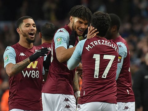 Trezeguet is mobbed by his Aston Villa teammates after his late winner against Leicester City in the League Cup semi-final.