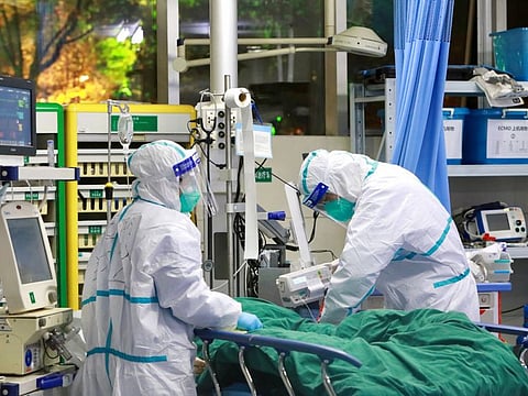 Medical staff in protective suits treat a patient with pneumonia caused by the new coronavirus at the Zhongnan Hospital of Wuhan University, in Wuhan, China on January 28, 2020.