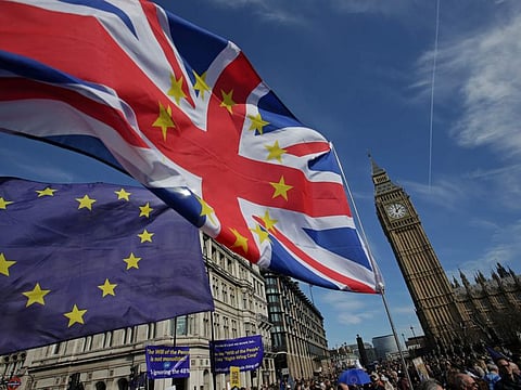 In this file photo demonstrators holding EU and Union flags gather in front of the Houses of Parliament in Parliament Square following an anti Brexit march in London, ahead of the British government's planned triggering of Article 50