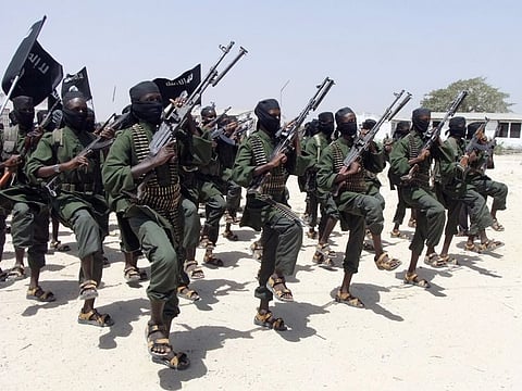 Al Shabab fighters perform military exercises in the Lafofe area some 18 km south of Mogadishu, in Somalia