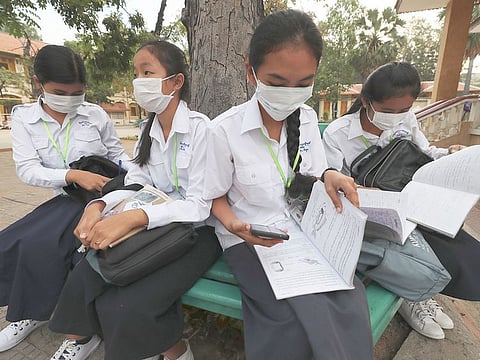 Students wear masks to avoid the contact of coronavirus before their morning class at a high school in Phnom Penh, Cambodia