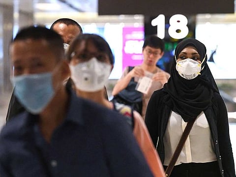 Travellers wearing face disembark at Changi international airport in Singapore.
