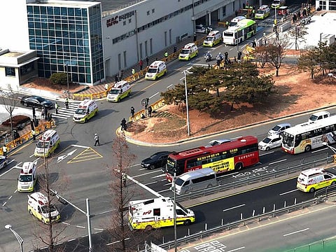 Ambulances carrying some South Korean evacuees from Wuhan, China, leave after arriving at Gimpo airport in Seoul, South Korea, Friday, Jan. 31, 2020. South Korea sent planes to fly back home more of their nationals from the Chinese city of Wuhan, the epicenter of a new virus.