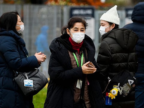 Passengers wearing respiratory masks exit the port of Civitavecchia, 70km north of Rome, early on January 31, 2020