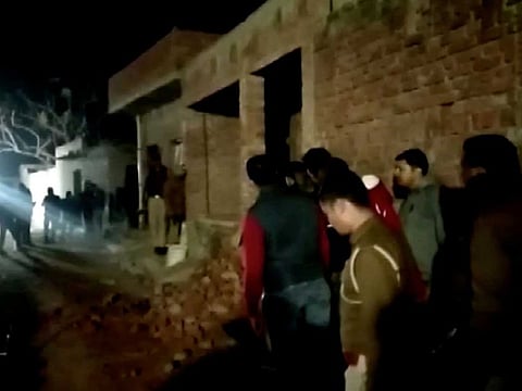 Residents and police personnel stand outside the building where a man has held hostages in Farrukhabad, Uttar Pradesh, India January 30, 2020 0 in this still image taken from video. According to sources, the captor first released a six-month-old girl Shabnam. His wife Ruby came on to the terrace to hand over the baby to the police.