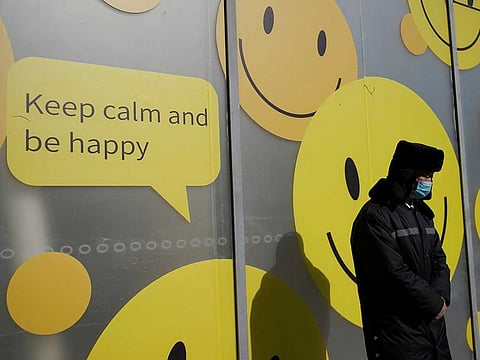 A security personnel wearing a face mask stands by a shopping mall in Beijing, China.