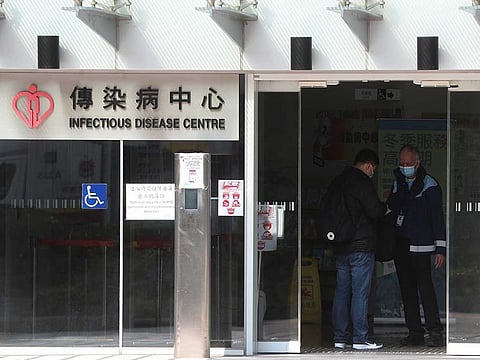 Security check a man inside the infectious disease centre at the Princess Margaret Hospital in Hong Kong.