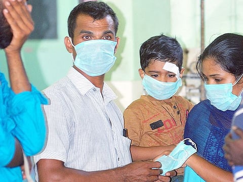 OPD patients and staff members wear safety masks as a precaution after the outbreak of coronavirus, at a hospital in Thrissur, Kerala.