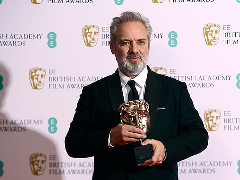 Director Sam Mendes poses with the Best Director award for 1917, backstage at the Bafta Film Awards, in central London, Sunday, Feb. 2, 2020.