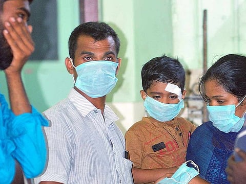 OPD patients and staff members wear safety masks as a precaution after the outbreak of coronavirus, at a hospital in Thrissur, on Friday.