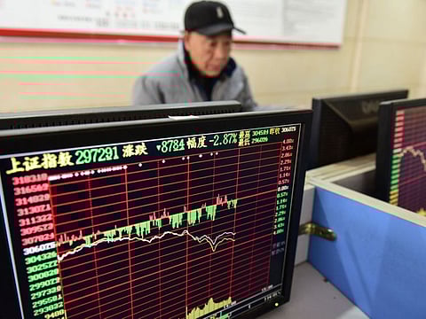 An investor looks at a screen showing stock market movements at a securities company in Fuyang in China's eastern Anhui province on January 23, 2020.