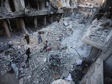 Members of the Syrian Civil Defence search through the rubble and debris in a building at the site of Russian air strikes on the town of Ariha in Idlib on January 30.