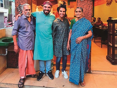 Khalid and Salama with Vijayan and Mohana in front their tea stall