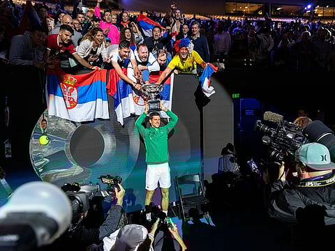 Novak Djokovic of Serbia holds the trophy after defeating Austria's Dominic Thiem to win the Australian Open