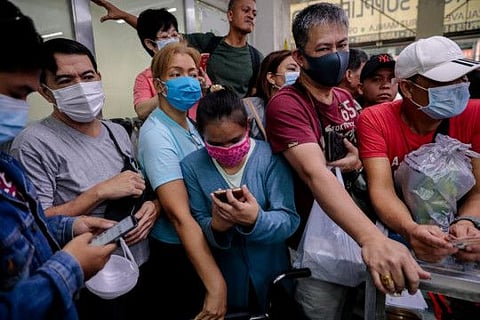 People scramble to buy face masks in a medical supply store a day after the Philippine government confirmed the first novel coronavirus case, in Manila, Philippines, January 31, 2020. REUTERS/Eloisa Lopez
