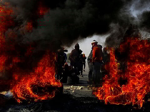 Iraqi demonstrators burn tyres to block a road during ongoing anti-government protests in Najaf, Iraq February 5, 2020.