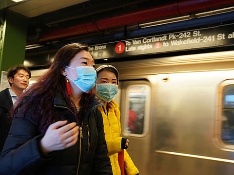 People wear surgical masks in the subway station at Times Square in New York, U.S., January 31, 2020.