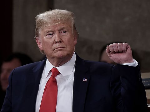 President Donald Trump pumps his fist as he delivers the State of the Union address in the chamber of the US House of Representatives at the US Capitol Building