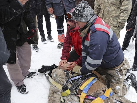Emergency service members give first aid to victim of an avalanche, near the town of Bahcesaray, in Van province, eastern Turkey, Wednesday.
