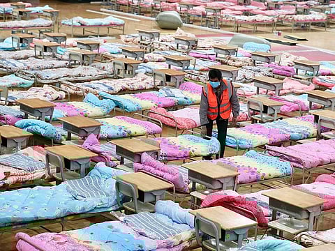 A worker sets up beds at the Hongshan Stadium to convert it into a makeshift hospital following an outbreak of the new coronavirus, in Wuhan, Hubei province, China.