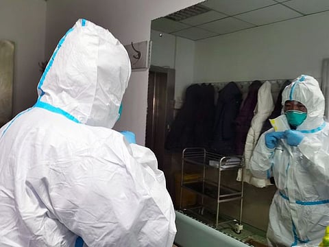A medic in China wearing a protective suit and mask before entering an isolation ward