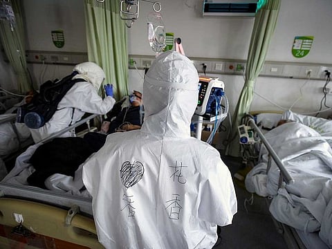 Medical workers in protective suits attend to novel coronavirus patients inside an isolated ward at a hospital in Wuhan, Hubei province, China February 6, 2020.