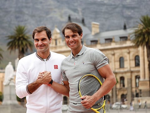 Roger Federer and Rafael Nadal pose for photographers ahead of their "Match in Africa" exhibition tennis match in Cape Town, South Africa.