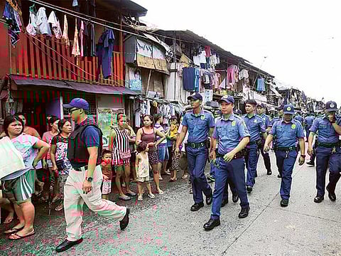 Policemen patrol around a slum area during a police operation as part of the continuing 'War on Drugs' campaign of Philippine President Rodrigo Duterte in Manila, Philippines.